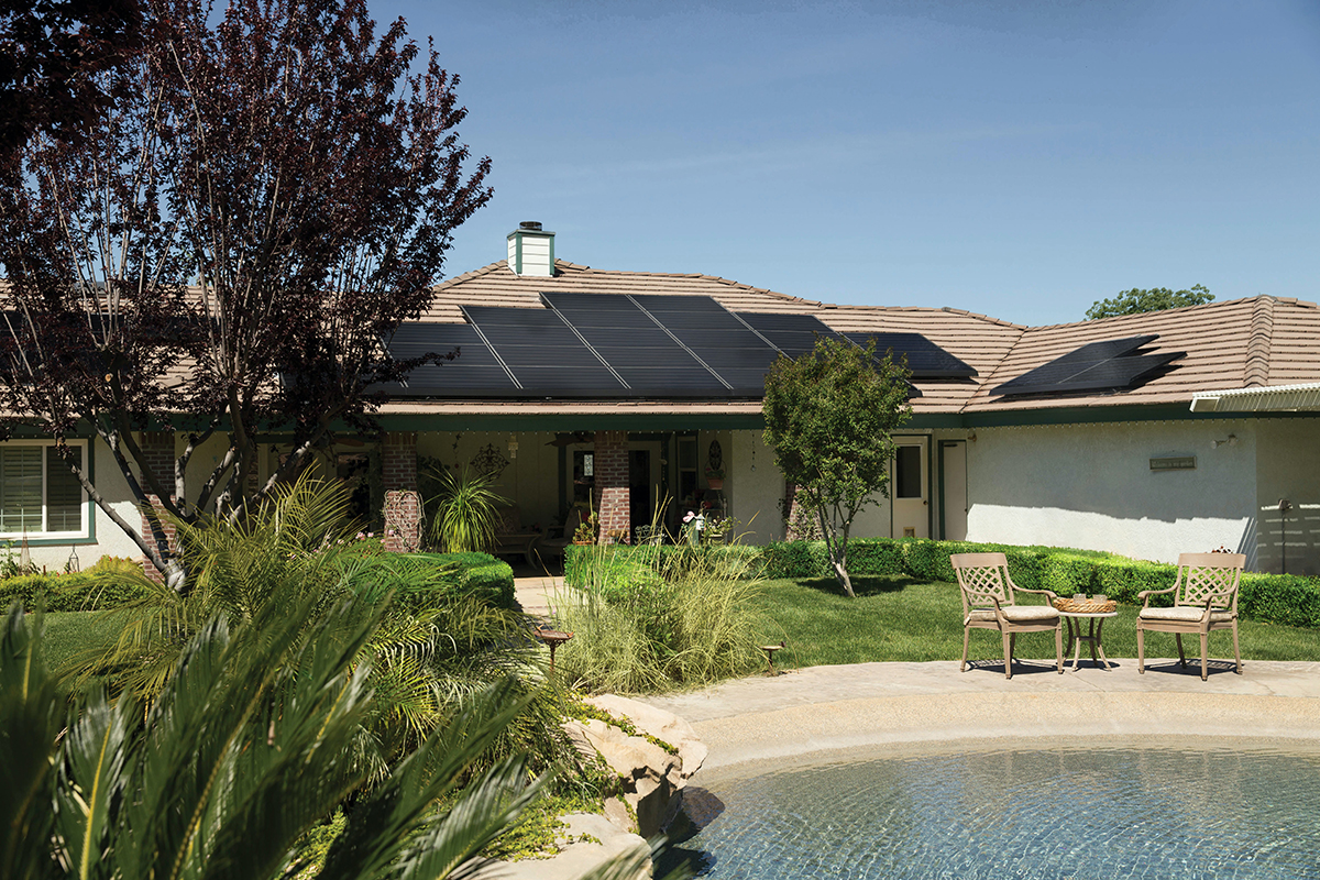 Ranch house in a warm climate with solar panels on roof.
