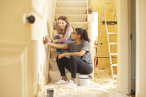 Two women looking at paint colors for a remodel