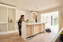 Two contractors working on a kitchen renovation