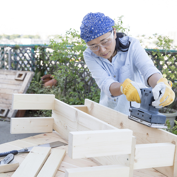 Woman building a wooden bench