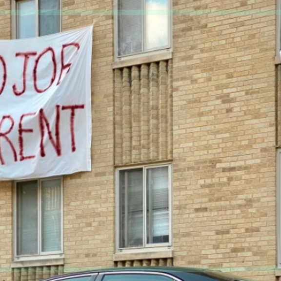 Apartment building with No Job, No Rent signs
