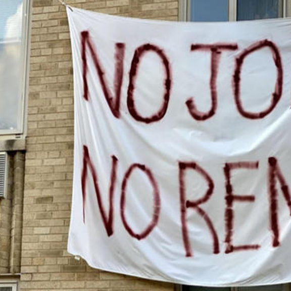 Sheet outside building with "no jobs, no rent" written on it.