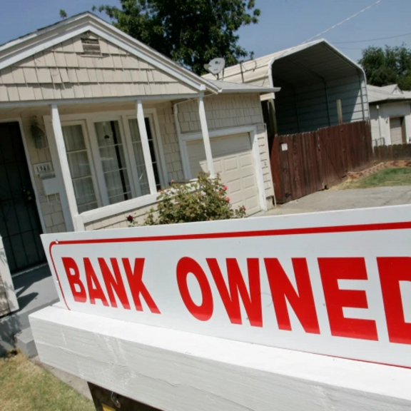 "Bank owner" sign in front of house.