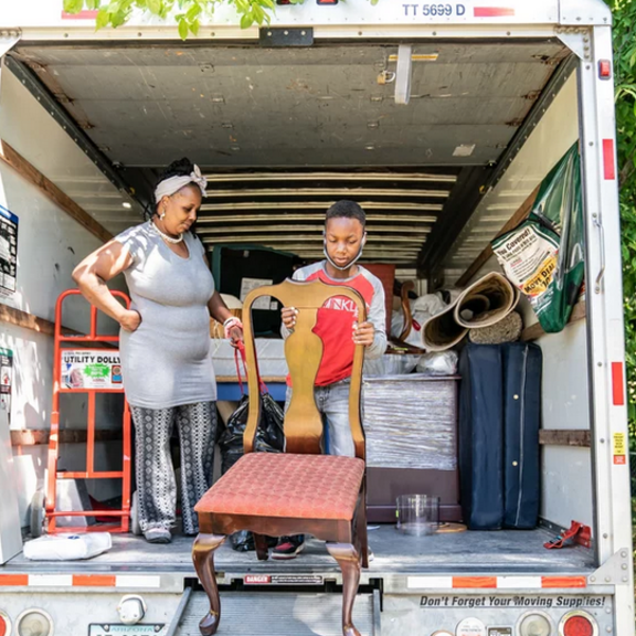 Tasharn Richardson's 11-year-old son, Lionel, helps unload the moving truck at their new home in Washington, DC.
