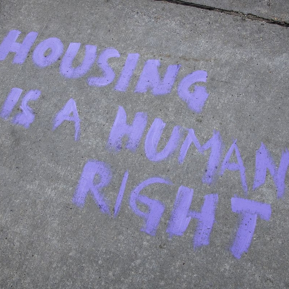 Graffiti stating "housing is a human right."