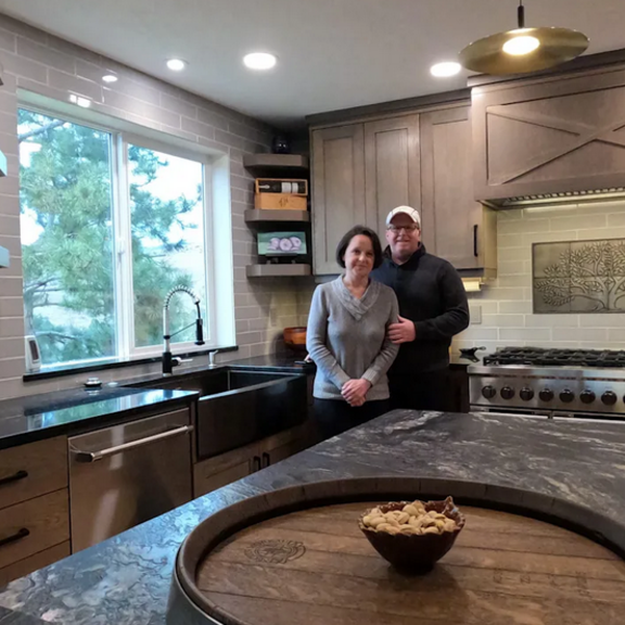 Couple standing in their remodeled kitchen.