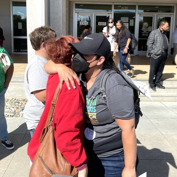  Janine Nkosi, a member of the Fresno-based advocacy group Faith in the Valley, hugs a resident of Trails End Mobile Home Park after a ruling to allow an investor group to buy the park.