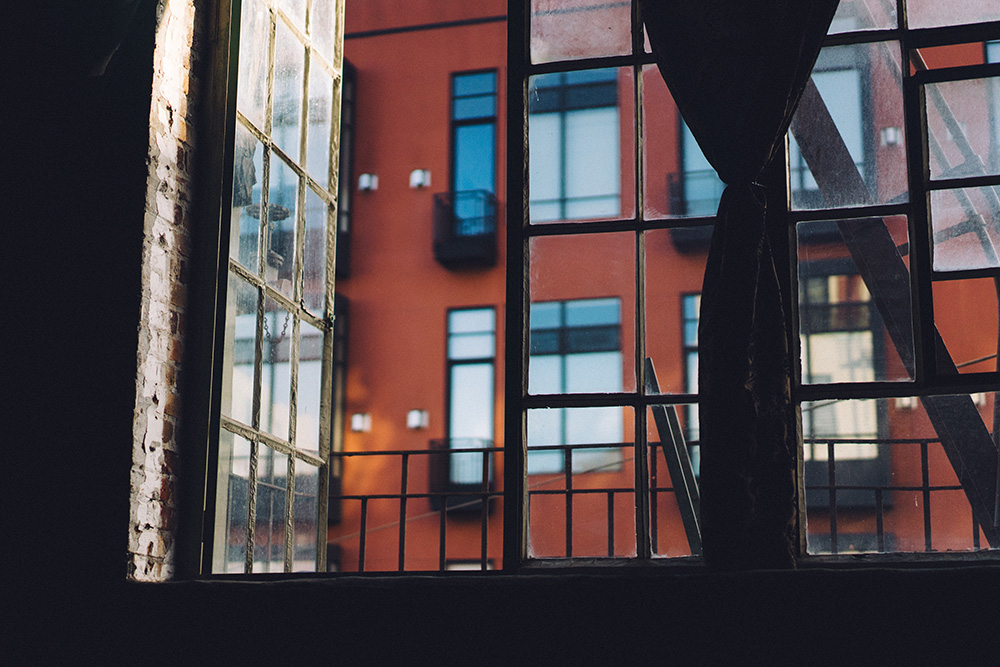 View of a brick multifamily building through a window.