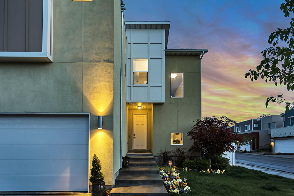 Front door of a house lit up at dusk.