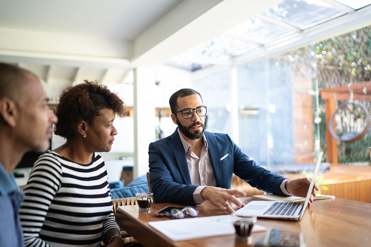 A couple reviewing options with their financial advisor.