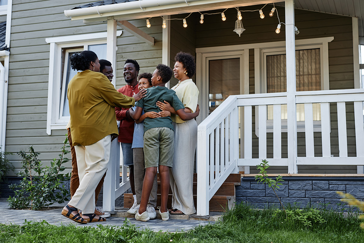 Family assembled on front steps of home.