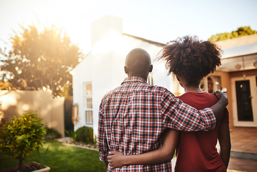 Black couple looking at a house