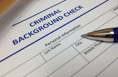 Criminal background check document with a pen