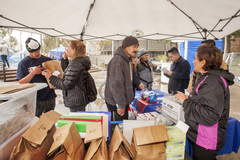 People socializing while distributing food.