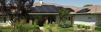 Ranch house in a warm climate with solar panels on roof.